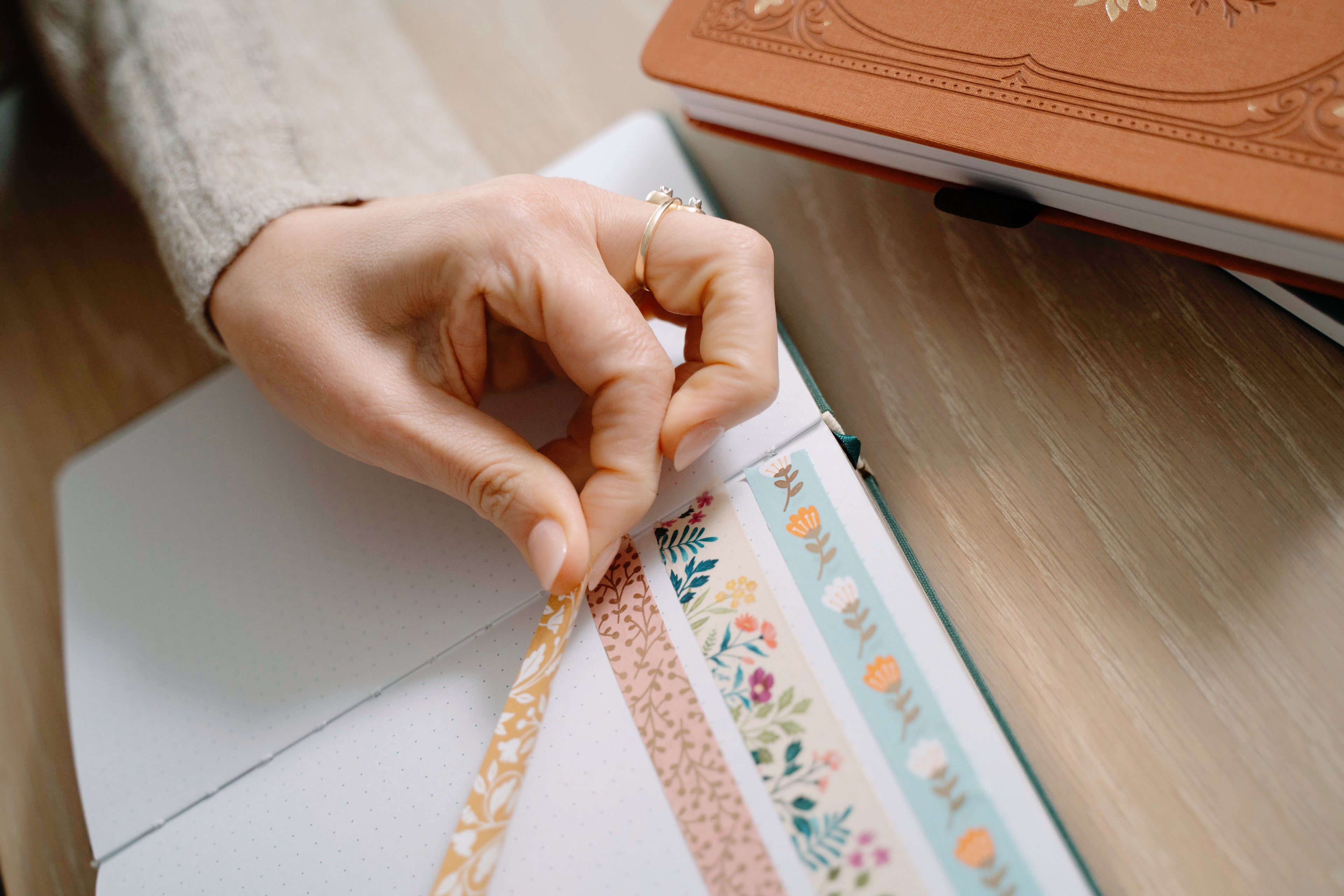A cozy moment of journaling surrounded by beautifully detailed notebooks, coffee, and soft natural light. These images capture the quiet joy of creativity and reflection.