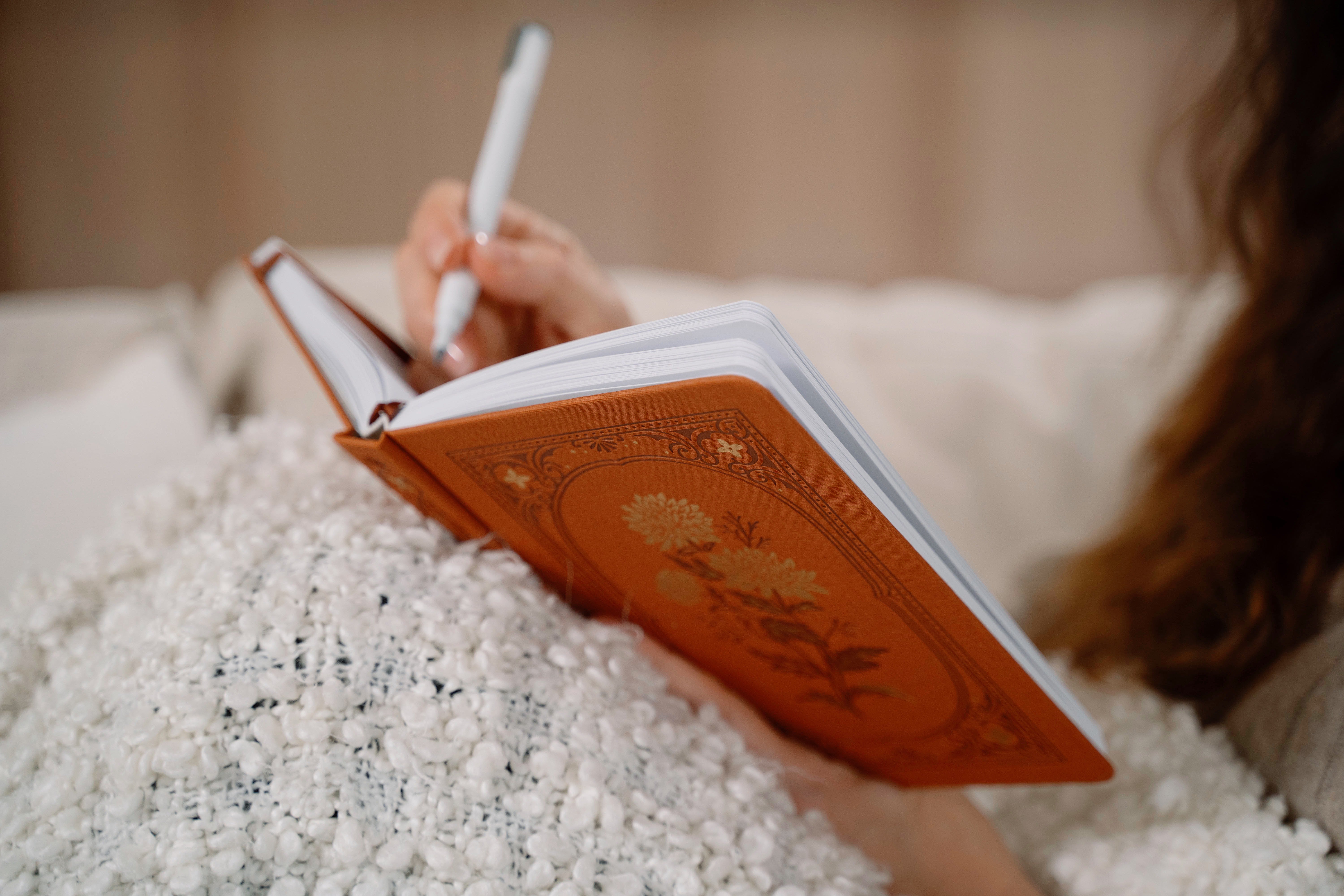 A cozy moment of journaling surrounded by beautifully detailed notebooks, coffee, and soft natural light. These images capture the quiet joy of creativity and reflection.