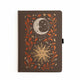  Dark buckram notebook with foiled celestial sun and moon design surrounded by autumn leaves