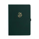 Dark green notebook with a gold floral design on a white background