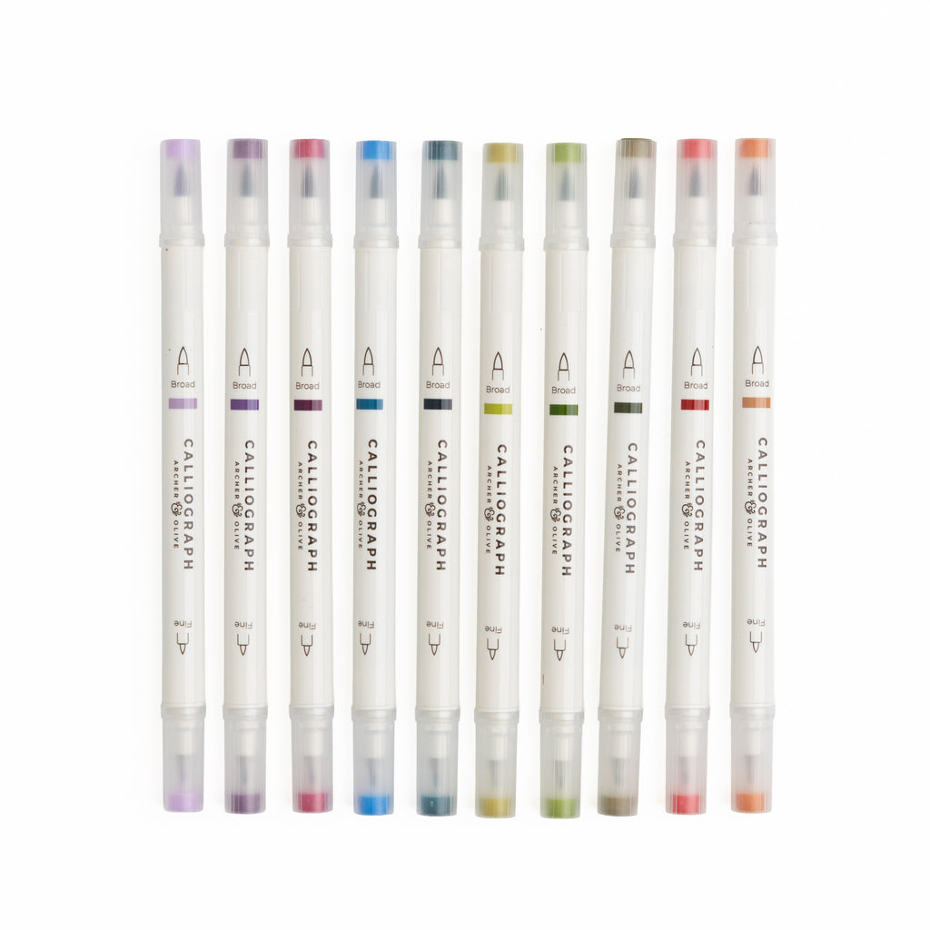 Set of Calligraphic markers with colored caps on a white background
