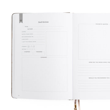 Open notebook with a page dedicated to book reviews on a white background